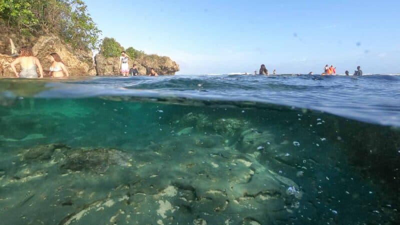 over under go pro photo showing above and belopw the surface of the water at Magpupungko