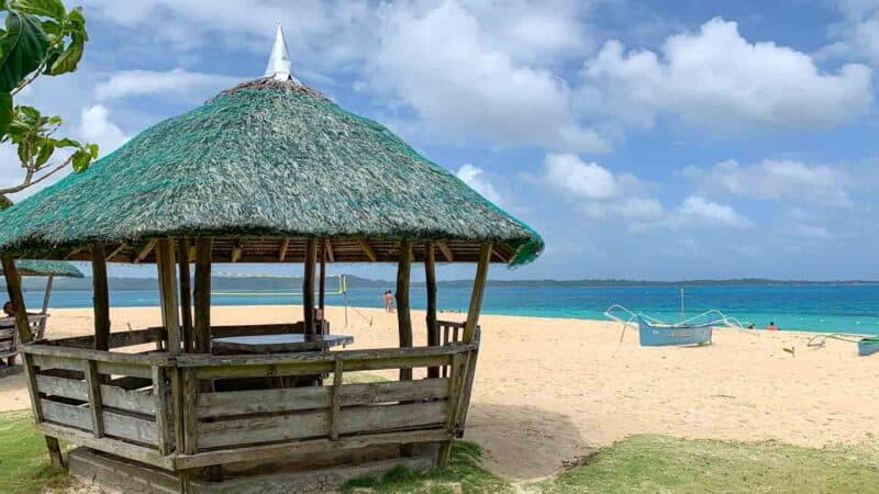 thatched pinic area of Daku Island right in the sand