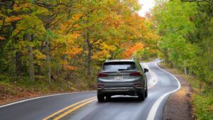 gray suv driving on M-26 on a road trip - Things to do in Copper Harbor Michigan