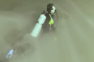 a diver copletely emmersed in the hydrogen sulfide cloud of cenote angelita