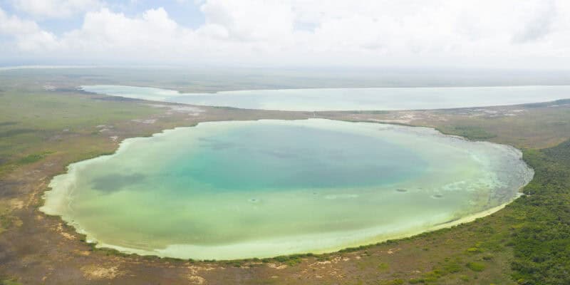 Muyil Panoramic Drone photo of lagoon with blue and teal waters surrounded by low jungle