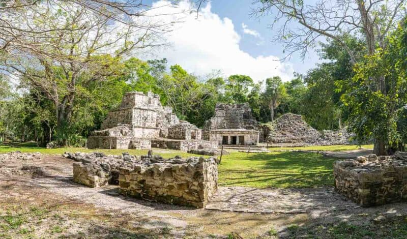 panoramic view of the stone buildings of the Plaza de entrada of Muyil Ruins