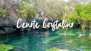 Two women jumping from the cliff jumping platform of Cenote Cristalino