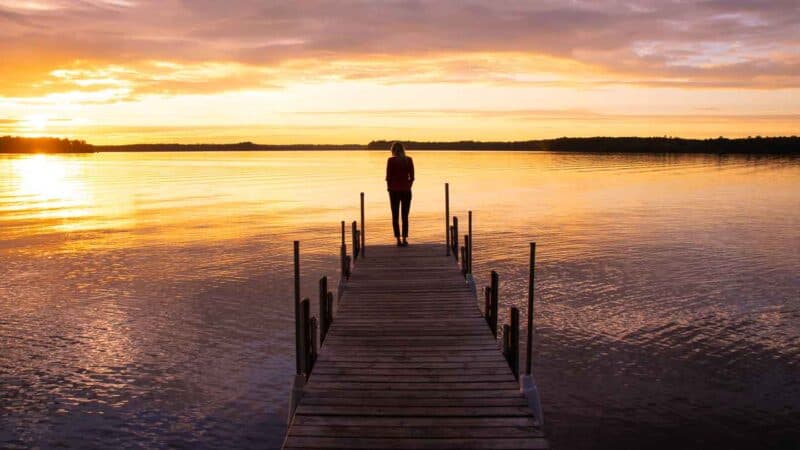 Woman standing on a dock in Minocqua Wisconsin a top destination in the state