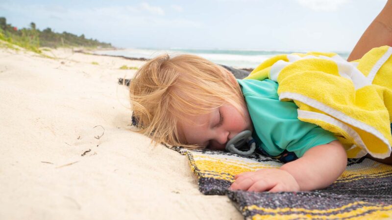 Toddler sleeping relaxing on Xcacel Beach