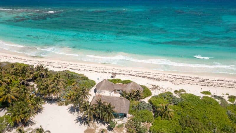 View of the thatched roof building of Playa Xcacel Turtle Sanctuary and beach