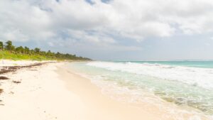 Panoramic view of Xcacel Beach with white sand and jungle