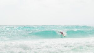 man surfing a medium sized wave at Xcacel Beach in Mexico