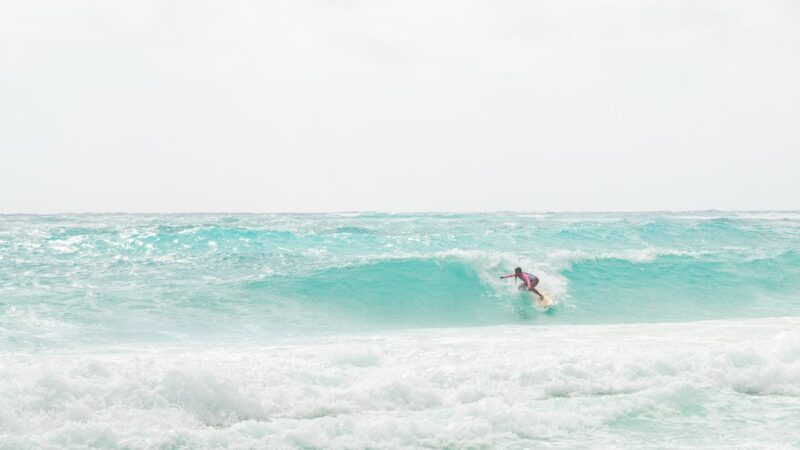 man surfing a medium sized wave at Xcacel Beach in Mexico