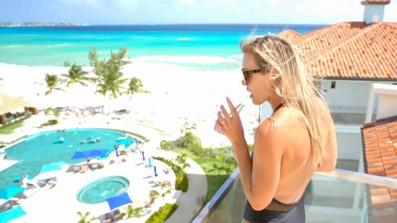 Woman drinking a drink at Sandals Rooftop bar in Barbados