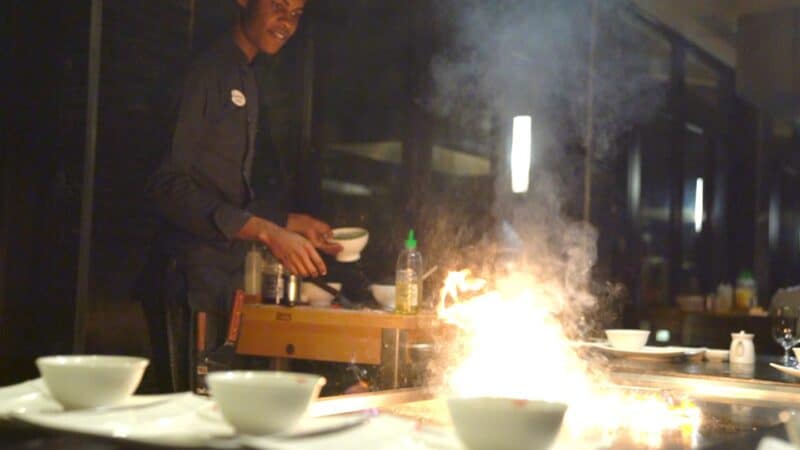 chef cooking at Kimonos restaurant at Sandals Resorts