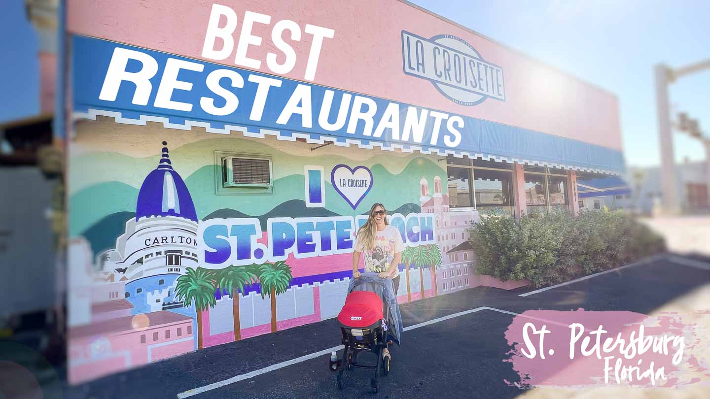 woman with a stroller standing in front of a pink building which is one of the best restaurants in St Petersburg FL - Featured Image