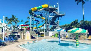 Waterslides with a pool with water umbrellas at splash harbor water park