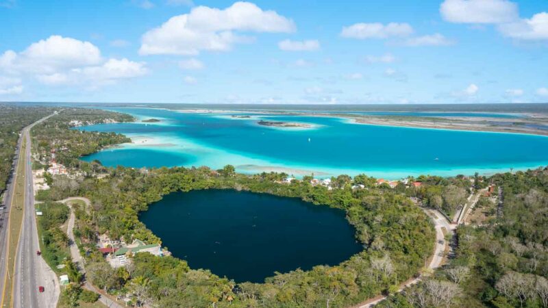 Panoramic view of Cenote Azul looking onto the colorful waters of Laguna Bacalar