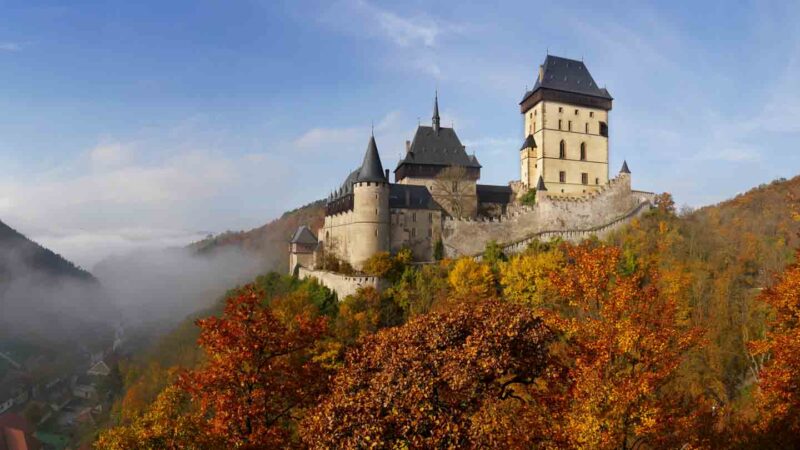 Fod and fall colors surround the Karlstejn Castle in the Czech Republic