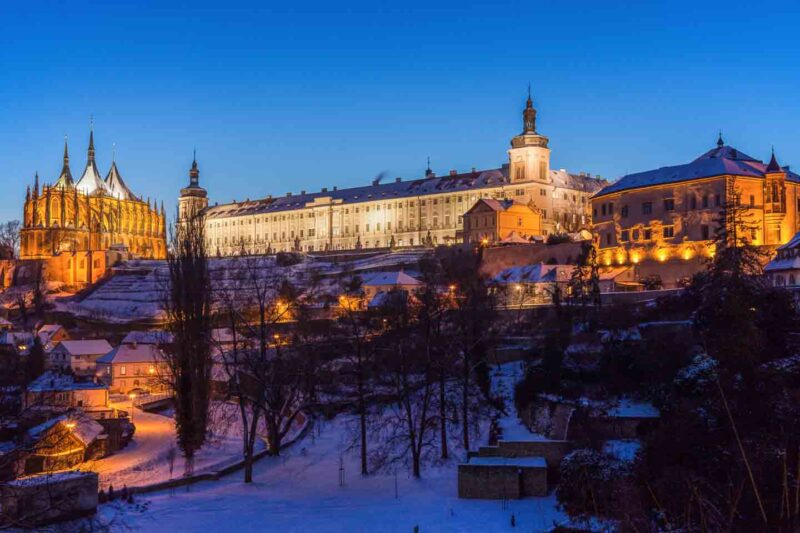 Buildings on a hill lit up at night in the city of Kutna Hora, Czech Republic