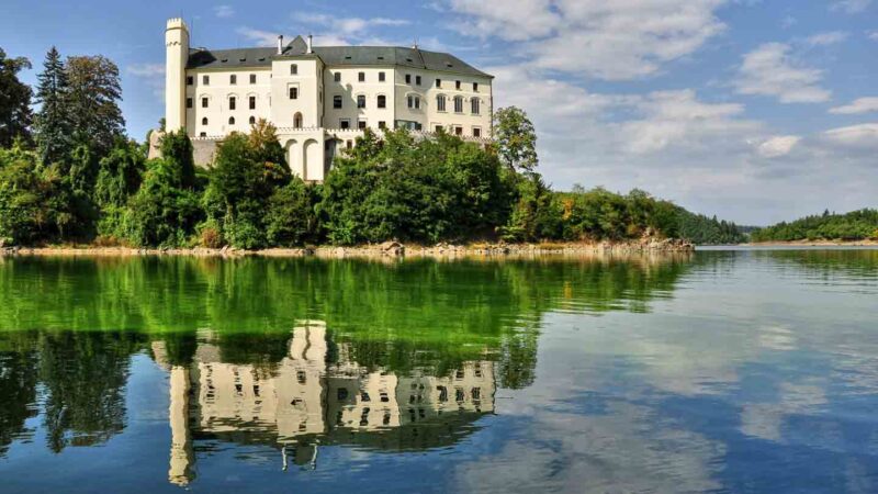 reflection view of Orlik Castle on the lake that surrounds the castle