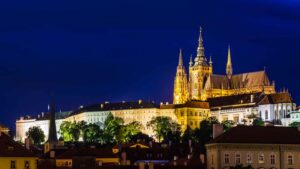view of Prague Castle at night with the largest castle in Czech Republic lit up with lights