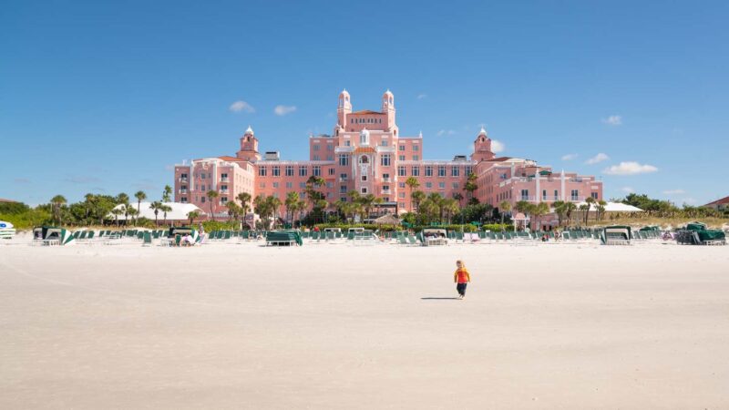 Boy playing on the beach in front of the pink Don Cesar Hotel on a Clearwater Beach Vacation