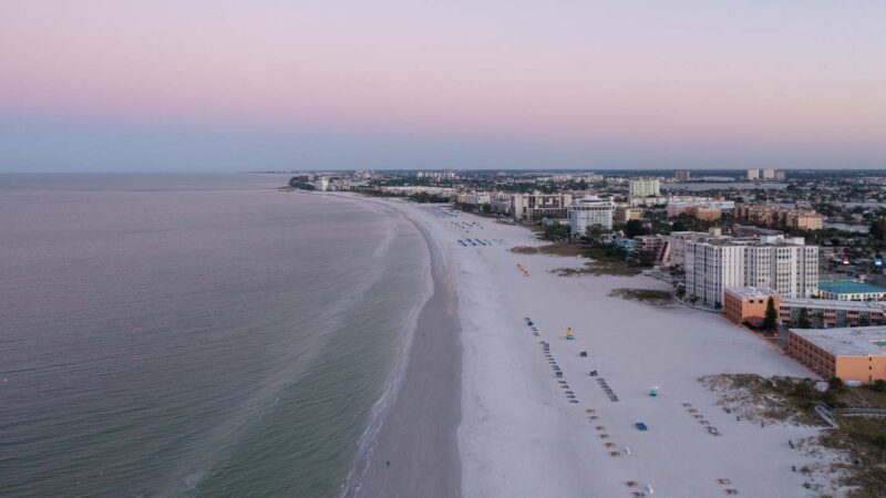 drone photo of St Pete Beach at sunrise with pink skies over the hotels and beach