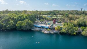 drone view of swimmers and snokelers at Cenote Azul in Bacalar Mexico near the Lagoon