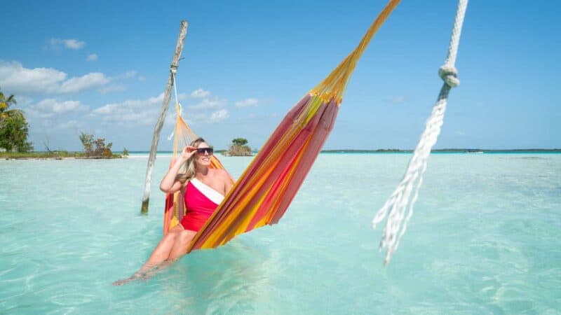 Woman in a red hammock in Cocalito Laguna Bacalar