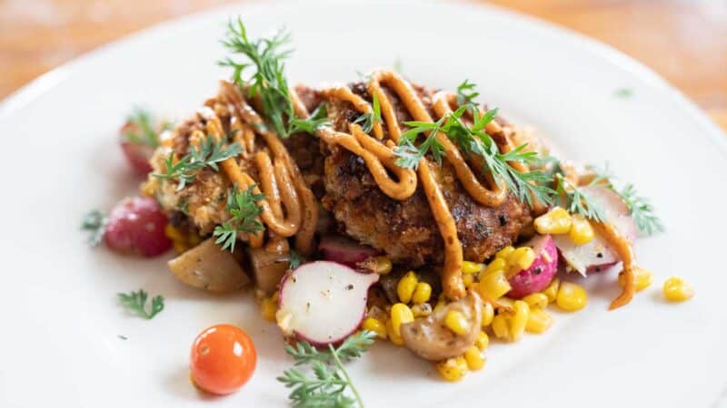 Crab Cakes with garnishes on a white plate