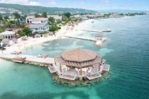 Drone photo of Latitude overwater bar at Sandals Montego Bay Resort with the hotel in background