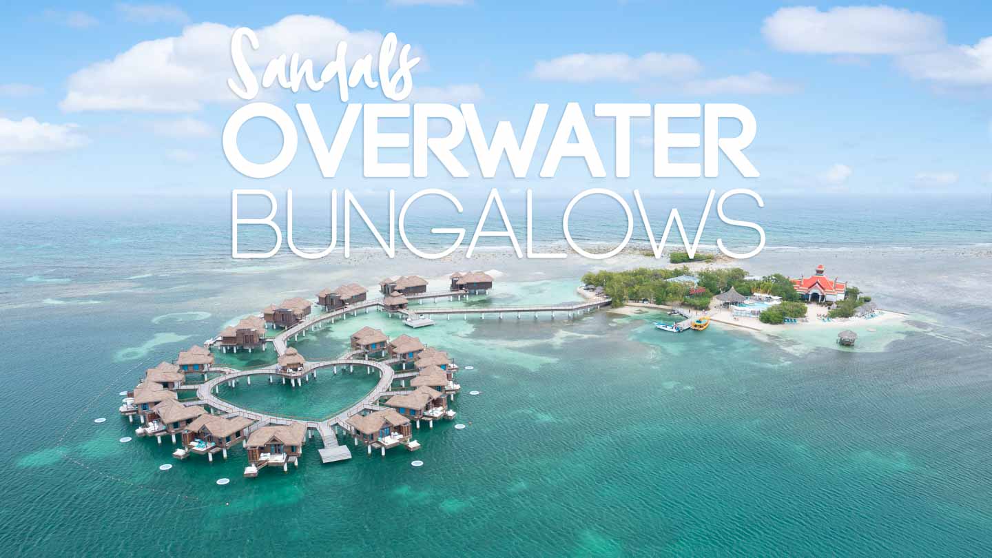 drone photo of Sandals Resorts Overwater Bungalows in the Carbibbean sea - Featured Image with white text