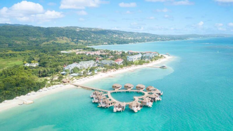 Panoramic Drone Photo of Sandals South Coast Resort in Jamaica with Overwater Bungalows in the foreground
