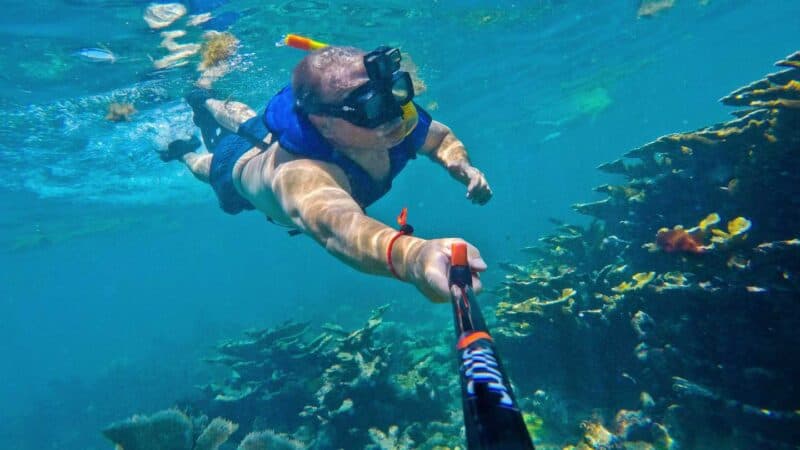 man with selfie stick snorkeling in Key Largo