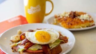 egg on top of breakfast sandwich and coffee at 2nd on Second restaurant in St. Petersburg Florida