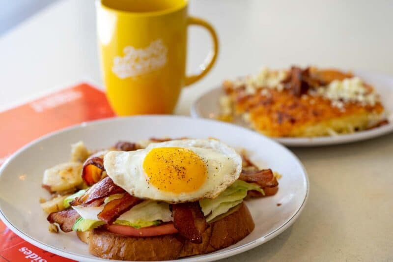 egg on top of breakfast sandwich and coffee at 2nd on Second restaurant in St. Petersburg Florida