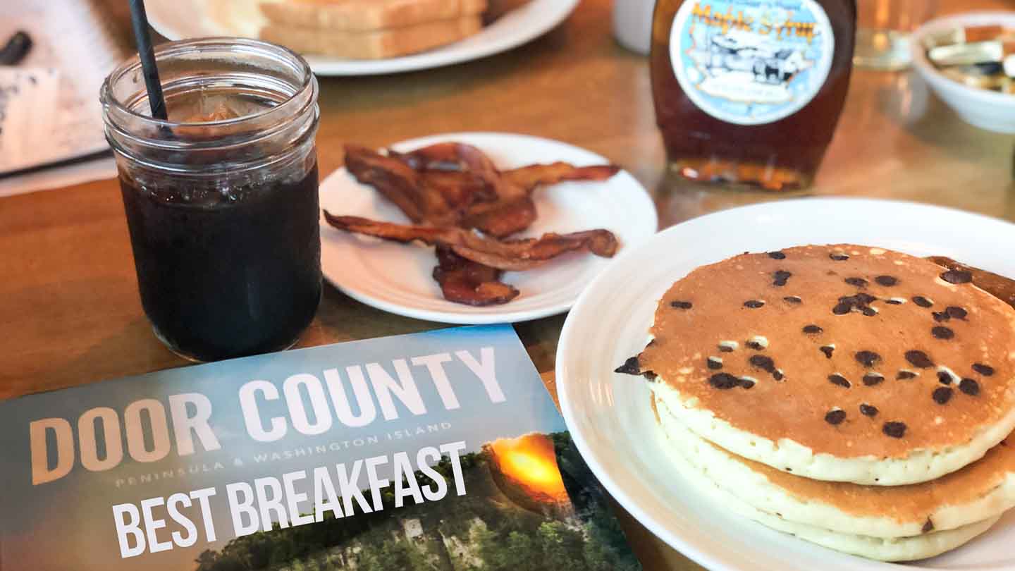 Table full of pancakes and bacon served at one of the best breakfast restaurants in Door County - Featured Image with white text