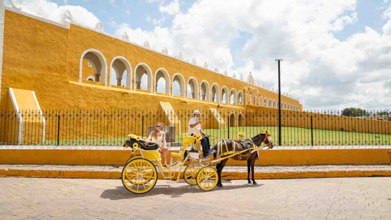 woman on a horse carriage tour of Izamal Mexico
