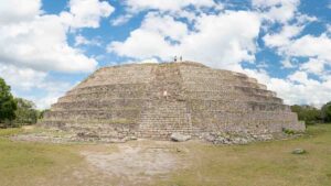 woman standing on Kinich Kakmp pyramid in Izamal Mexico