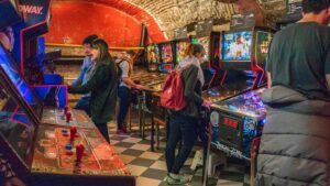 View of people playing games at the Budapest Pinball Museum