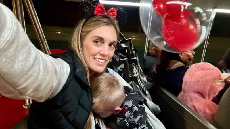 mom and son on Disney tram with folded stroller