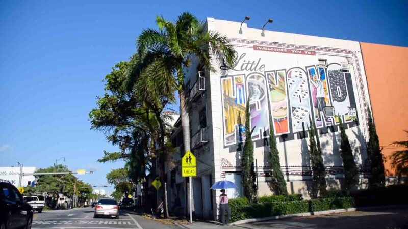 building with a large mural in a retro postcard style spelling Little Havana - a must visit area of Miami
