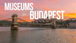 View over the Danube river showing the chain bridge and Budapest History Museum for the featured image with white text