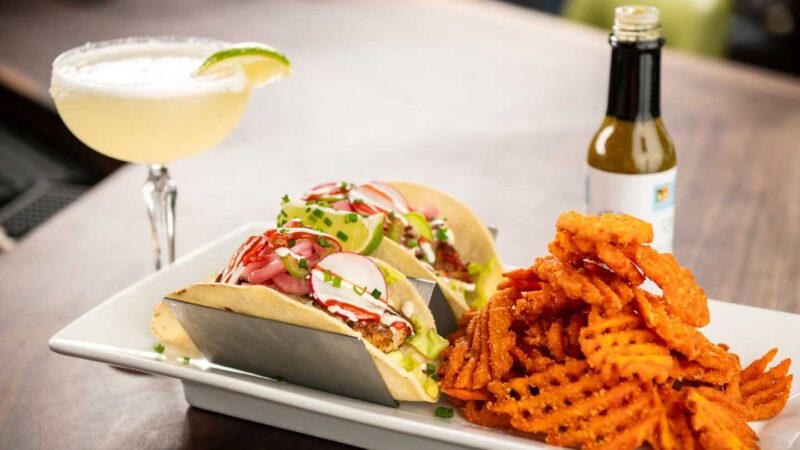 fish tacos and waffle fries with a margarita at one of the best restaurants in Islamorada Square Grouper