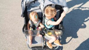 two kids in a double stroller Zoe