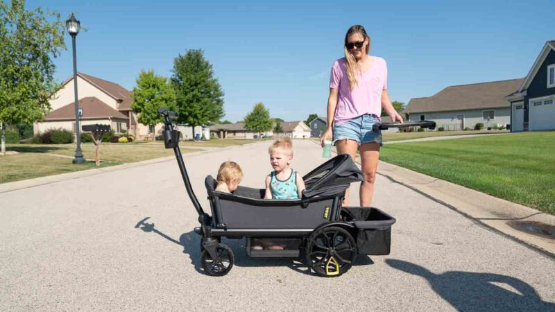 two toddlers in a Veer wagon
