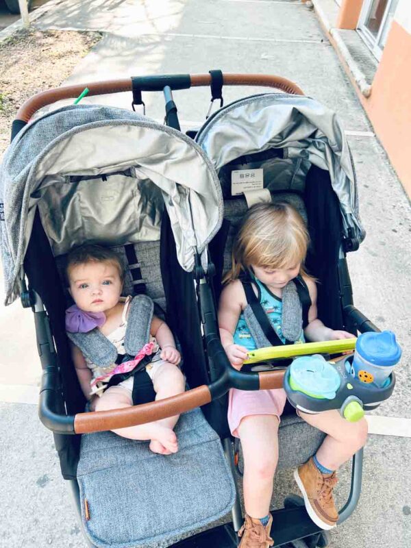 two children in the Zoe Twin double stroller