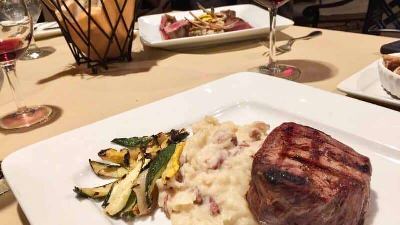 steak and potatoes on a plate at a restaurant