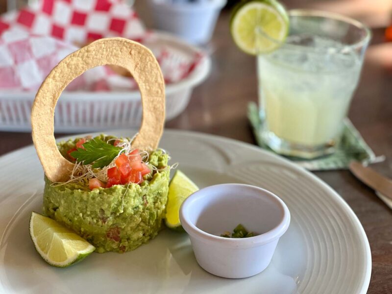 guacamole and chips with a margarita