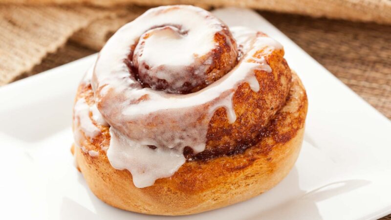 Fresh cinnamon roll with frosting on a plate