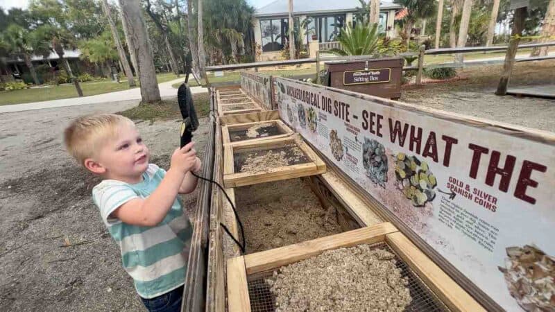 Children digging for treasure at an archeological exhibit at the fountain of youth