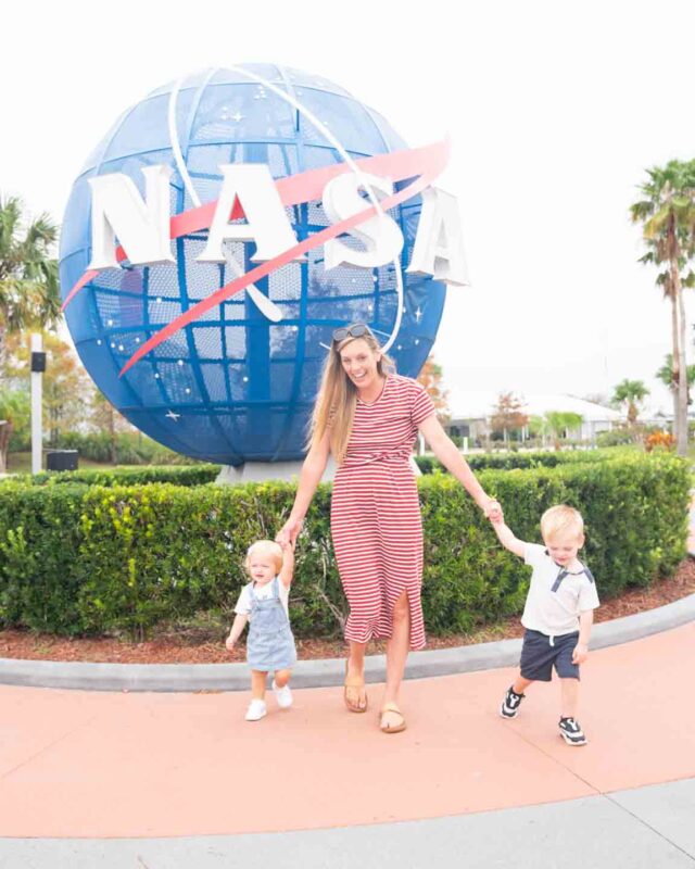 Woman and kids standing in front of the NASA Globe at the Kennedy space Center