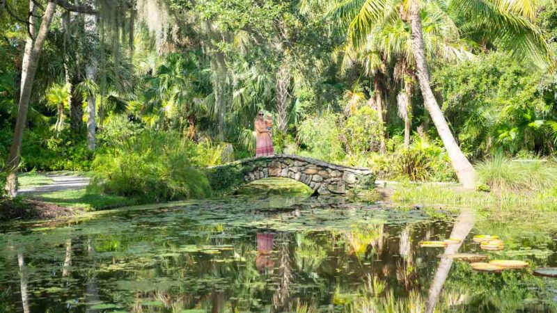 Woman walking on a bridge inside the McKee Botanical Gardens in Vero Beach Florida - family getaway